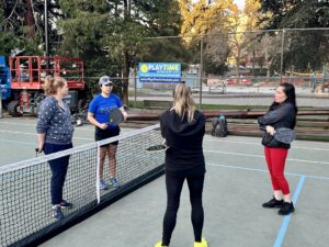 4 pickleball players on a court