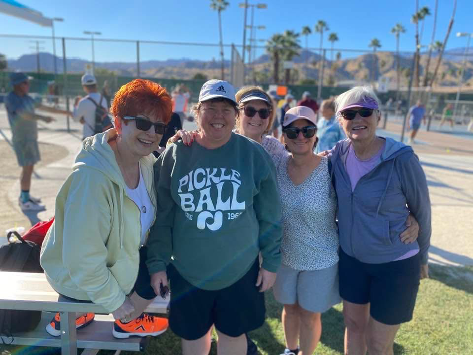 Group of female pickleball players at a court in Palm Springs